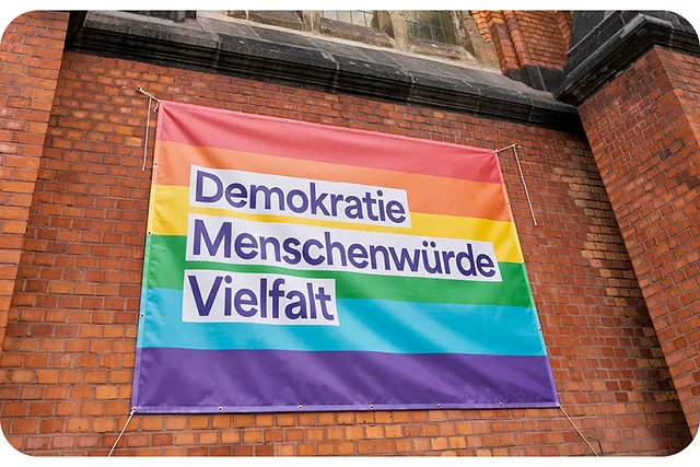 Banner an der Johanneskirche: Demokratie, Menschenwürde, Vielfalt
